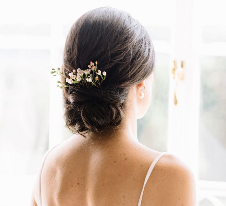 Low pinned up bun bridal Hairstyle with comb hair accessory