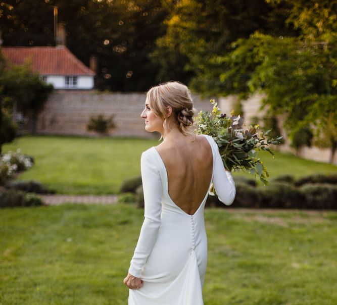 Beautiful Bride in Long Sleeve Wedding Dress with Backless Button Detail