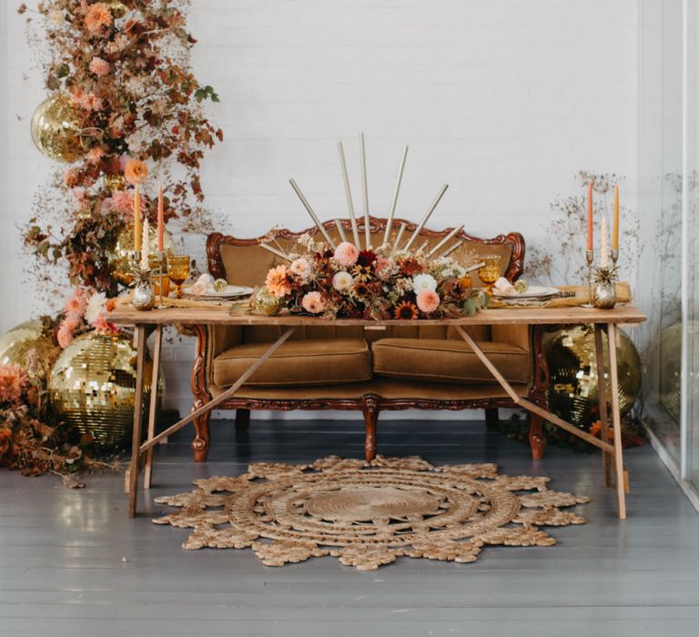 Tablescape with brown sofa and autumnal flower arrangement