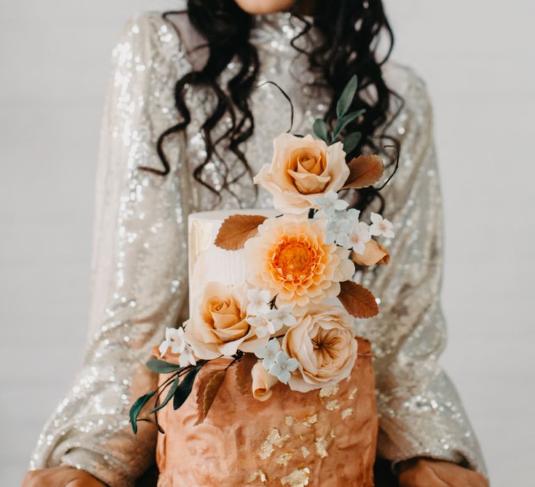 Wedding cake with rust and gold decor