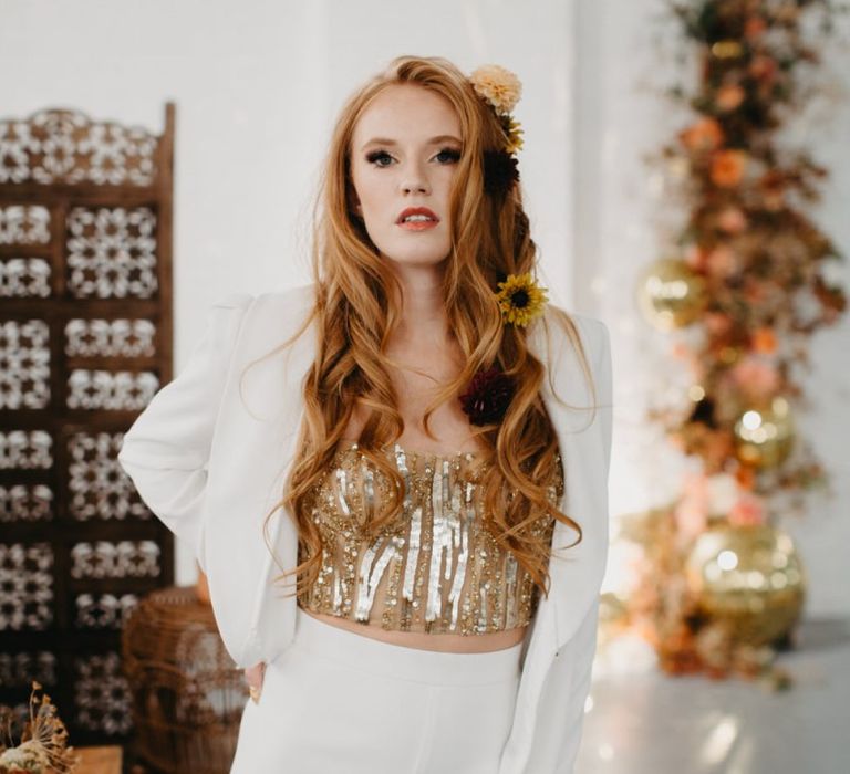 Beautiful bride in gold sequin corset and white trouser suit