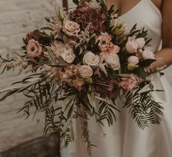 Oversized Romantic Bridal Bouquet with Pink Roses, Dahlias, Hydrangeas &amp; Foliage | Romantic Pink and Gold Wedding Inspiration in a Modern Summer House at Garthmyl Hall by KnockKnockPenny Studio | Nesta Lloyd Photography