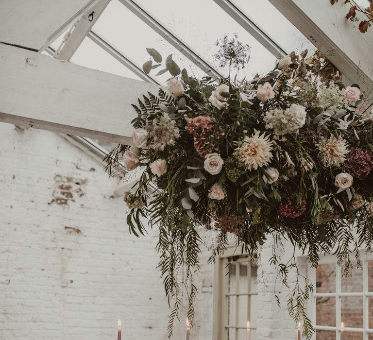 Hanging Floral Installation &amp; Tablescape with Floral Centrepieces &amp; Taper Candles | Romantic Pink and Gold Wedding Inspiration in a Modern Summer House at Garthmyl Hall by KnockKnockPenny Studio | Nesta Lloyd Photography