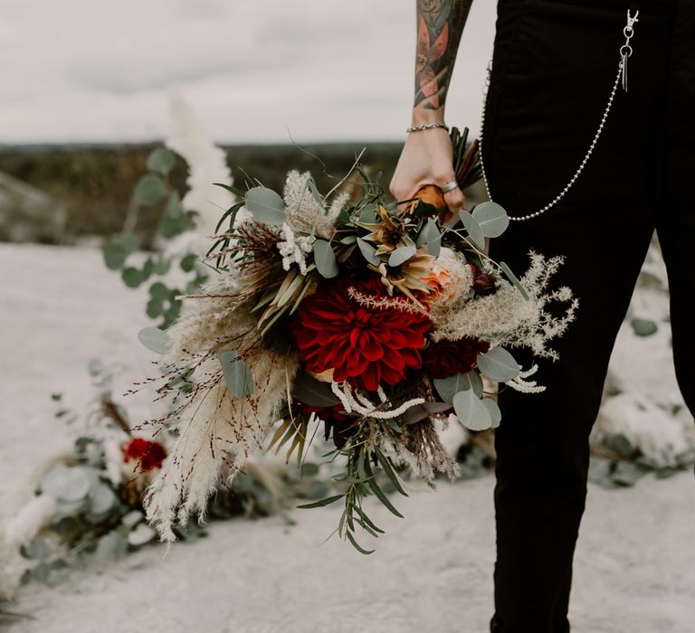 Bride in Trousers, White Shirt &amp; Braces | Pampas Grass, Eucalyptus &amp; Red Rose Wedding Bouquet | Horseshoe Pampas Grass, Eucalyptus &amp; Red Rose Floral Arrangement | Wild Same Sex Couple Wedding Inspiration Shoot | Anne Letournel Photography