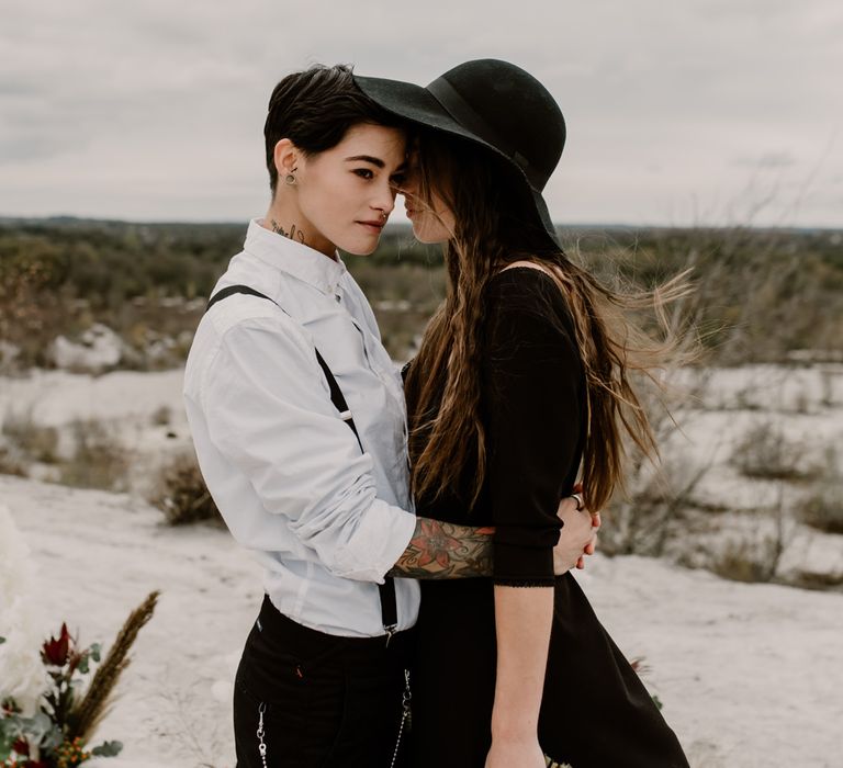 Bride in Portez Vos Idées Black Wedding Dress | Bride in Black Trousers, White Shirt &amp; Braces | Wild Same Sex Couple Wedding Inspiration Shoot | Anne Letournel Photography