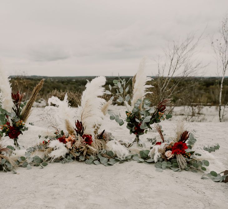 Horseshoe Pampas Grass, Eucalyptus &amp; Red Rose Floral Arrangement | Wild Same Sex Couple Wedding Inspiration Shoot | Anne Letournel Photography