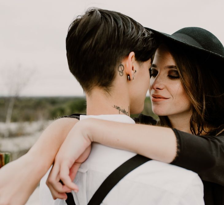 Bride in Portez Vos Idées Black Wedding Dress | Bride in Black Trousers, White Shirt &amp; Braces | Wild Same Sex Couple Wedding Inspiration Shoot | Anne Letournel Photography