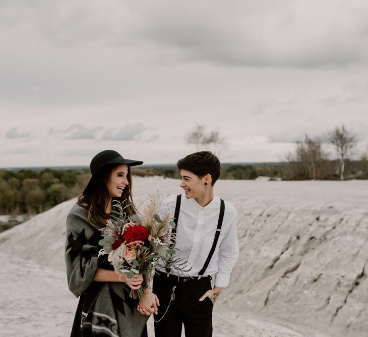 Bride in Portez Vos Idées Black Wedding Dress | Bride in Black Trousers, White Shirt &amp; Braces | Wild Same Sex Couple Wedding Inspiration Shoot | Anne Letournel Photography