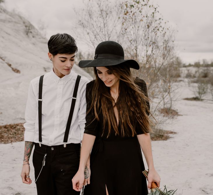 Bride in Portez Vos Idées Black Wedding Dress | Bride in Black Trousers, White Shirt &amp; Braces | Wild Same Sex Couple Wedding Inspiration Shoot | Anne Letournel Photography