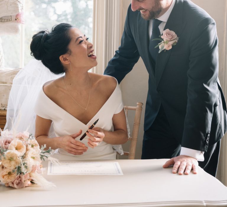 Bride and groom exchanging vows at Aynhoe Park wedding ceremony