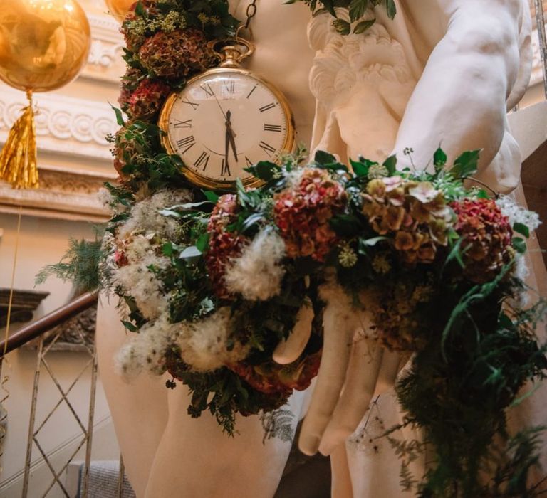 Aynhoe Park statue decorated in red hydrangea autumn flowers