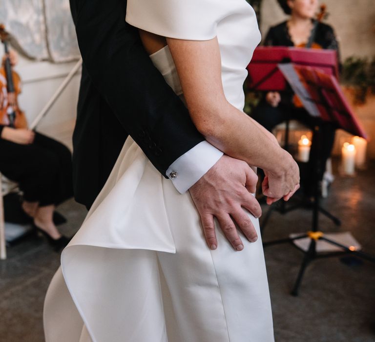 Groom with his arm around his new bride