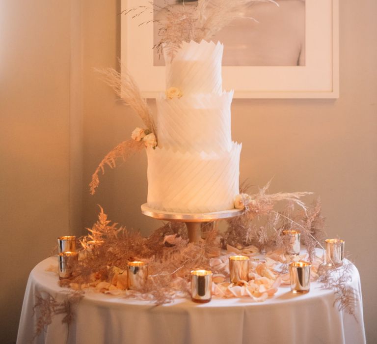 Opulent white wedding cake by Dees Basement