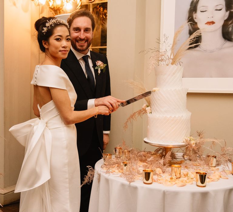 Bride and groom cutting the cake at Aynhoe Park