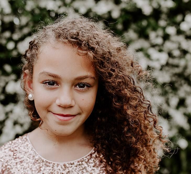 Beautiful flower girl with naturally curly hair