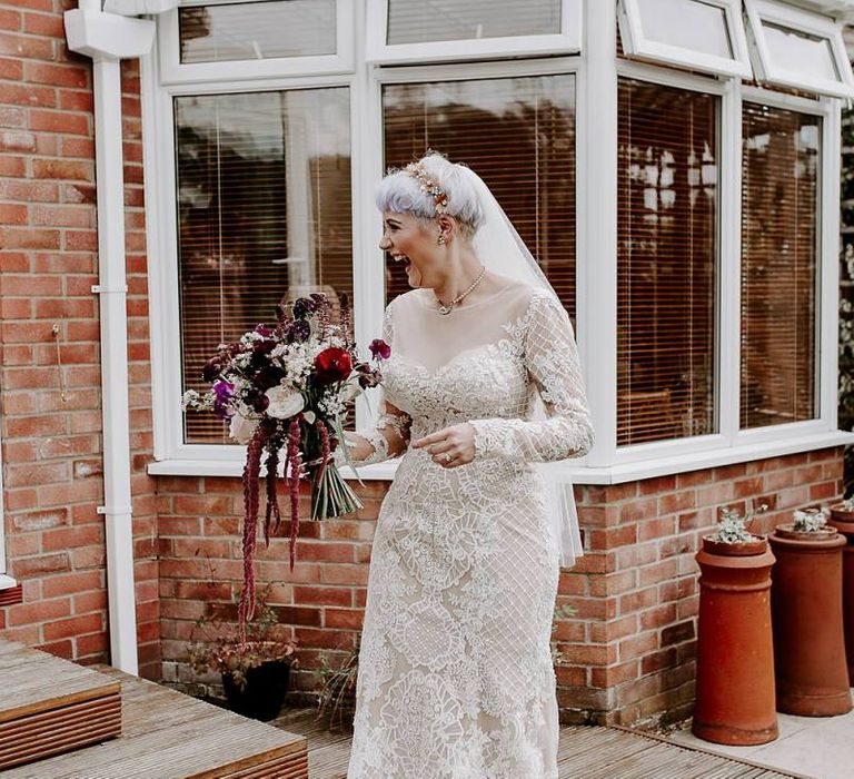 Boho bride in lace Lillian West wedding dress with long sleeves