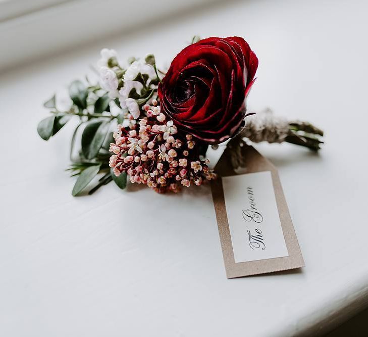 Deep pink buttonhole for the groom