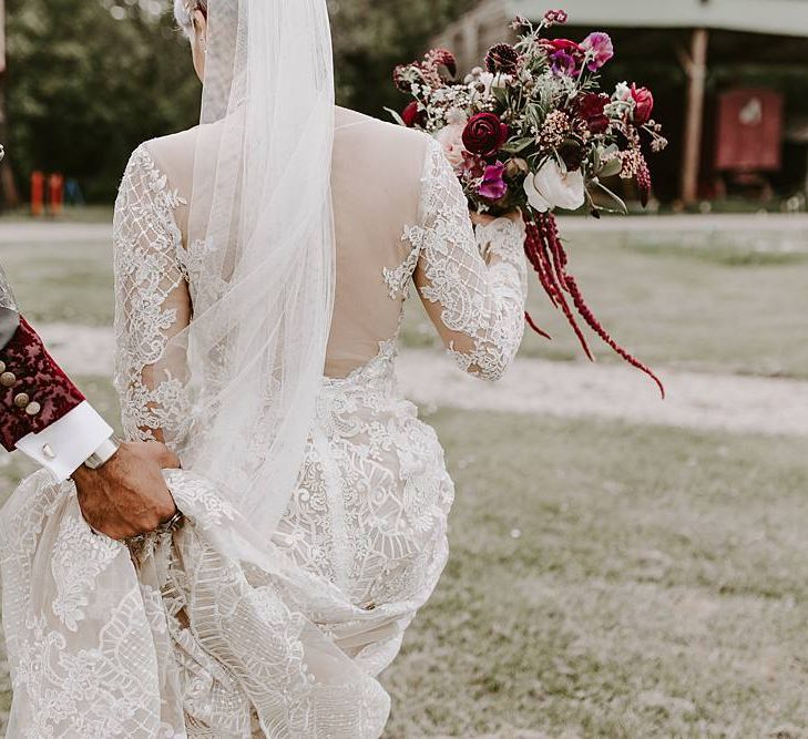 Bride in backless Lillian West wedding dress