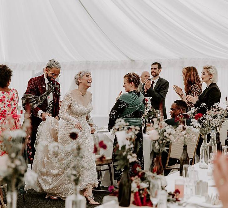 Bride and groom entering their marquee wedding reception