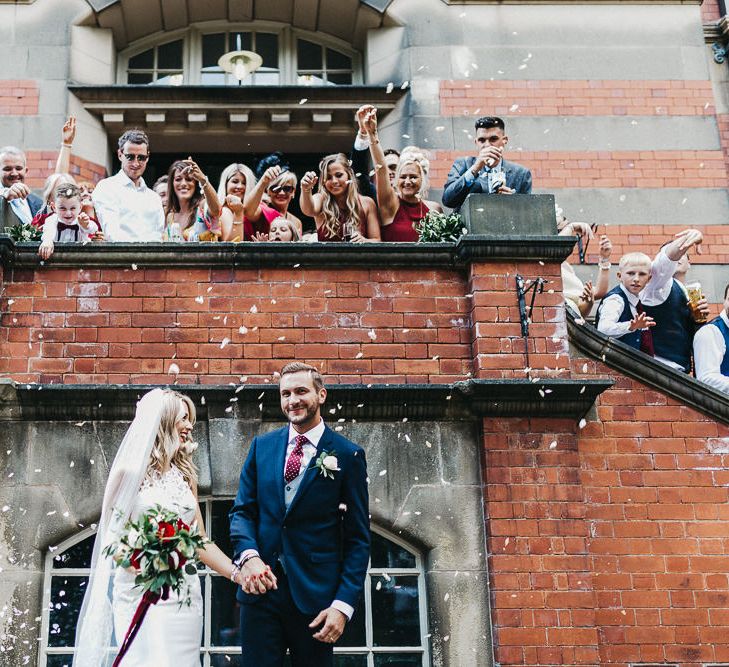 Confetti Moment | Bride in Lace Racerback Essence of Australia Wedding Dress | Groom in Navy Suit from Coneys of Lincoln | Nottinghamshire Wedding with Spanish Vibes and Rewritten Bridesmaids Dresses | Kev Elkins Photography