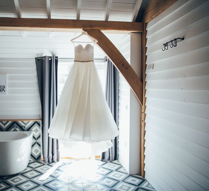 Strapless Ballgown Dress by Pronovias with Crystal Belt | Gypsophila Arch and Giant Balloons for an Outdoor Coastal Wedding | Toby Lowe Photography