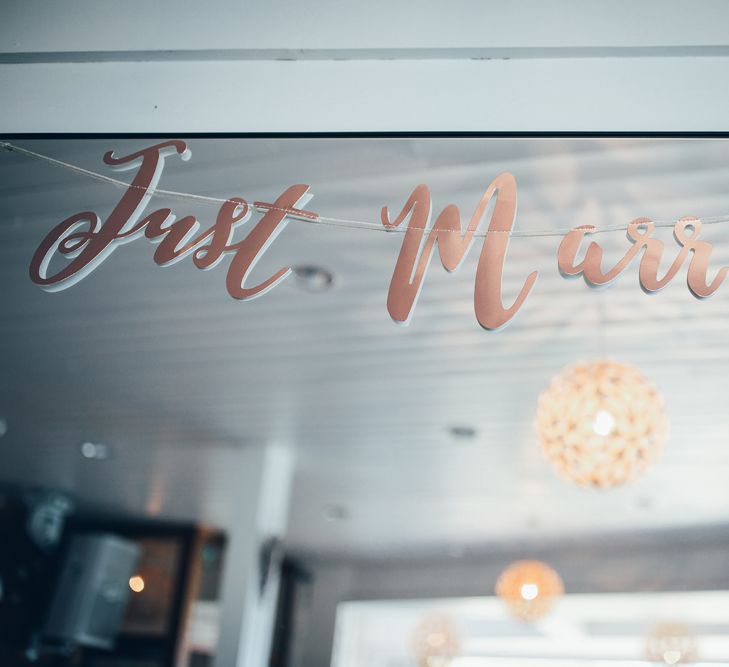 Copper Just Married Banner | Wedding Reception Décor | Gypsophila Arch and Giant Balloons for an Outdoor Coastal Wedding | Toby Lowe Photography