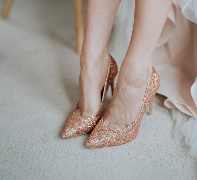 Brides glitter shoes at Oxford wedding teamed with delicate lace dress