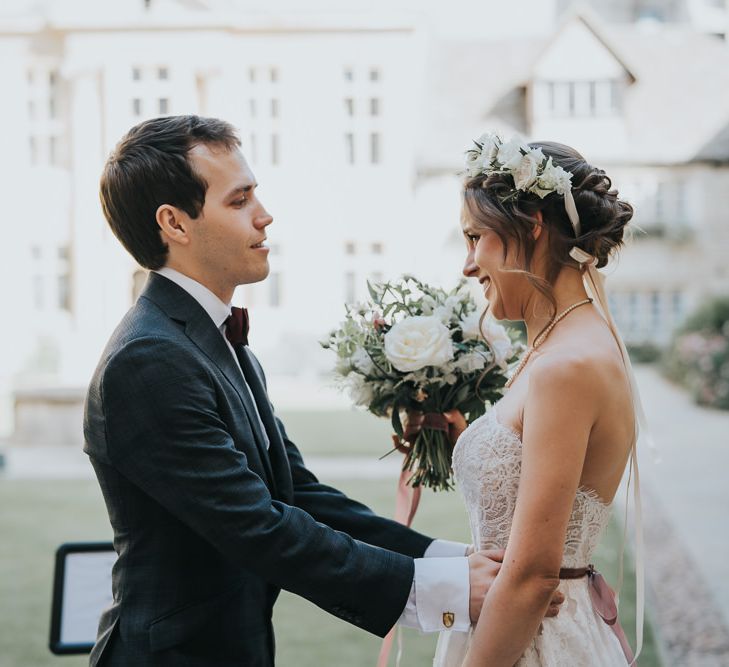 Bride and groom first look for intimate celebration with flower crown  and white floral bouquet