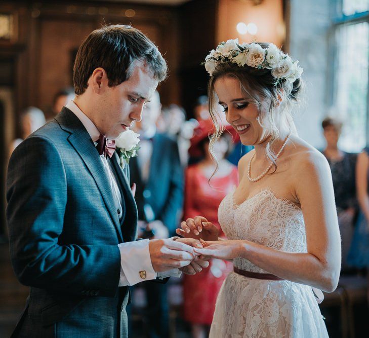 Intimate Oxford wedding ceremony with white flower decor and lace detailed dress