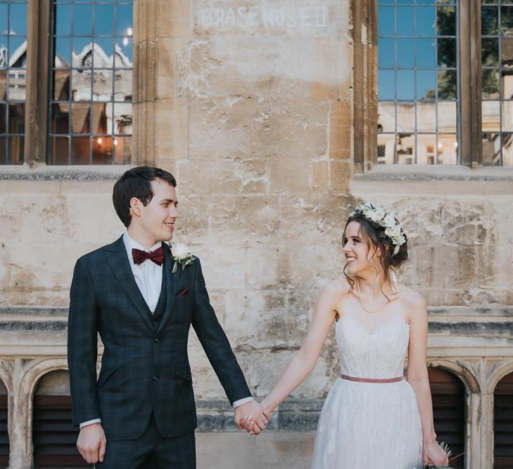 Bride and groom tie the knot at intimate Oxford wedding with a white floral bouquet and a flower head crown