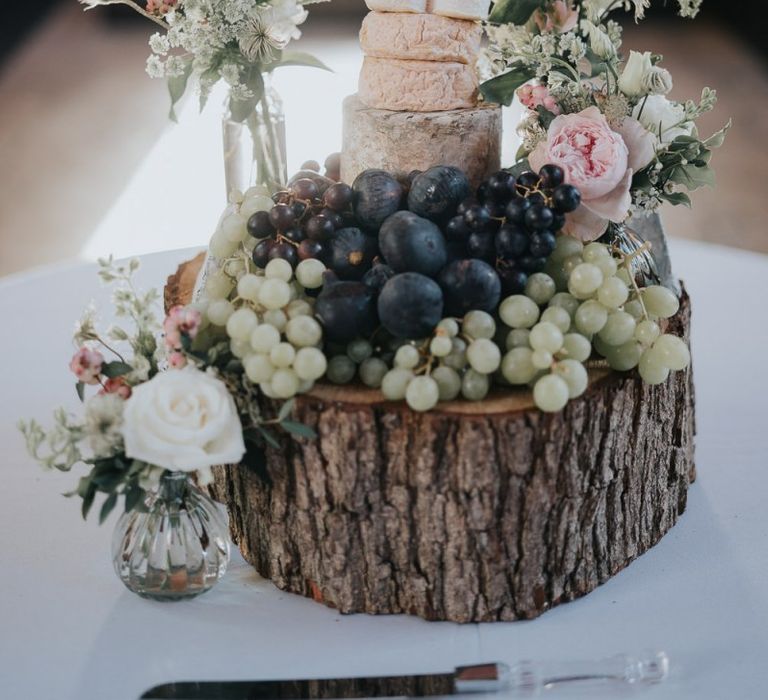 Cheese tower wedding cake served on a tree stump for classic reception at Bodleian library