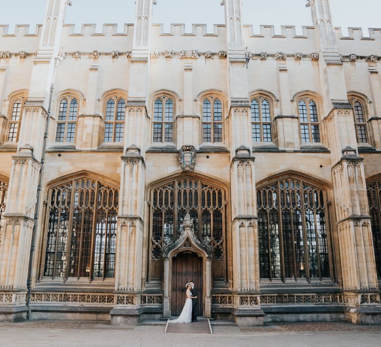 Bride and groom steal a moment at relaxed Oxford wedding reception at Bodleian library