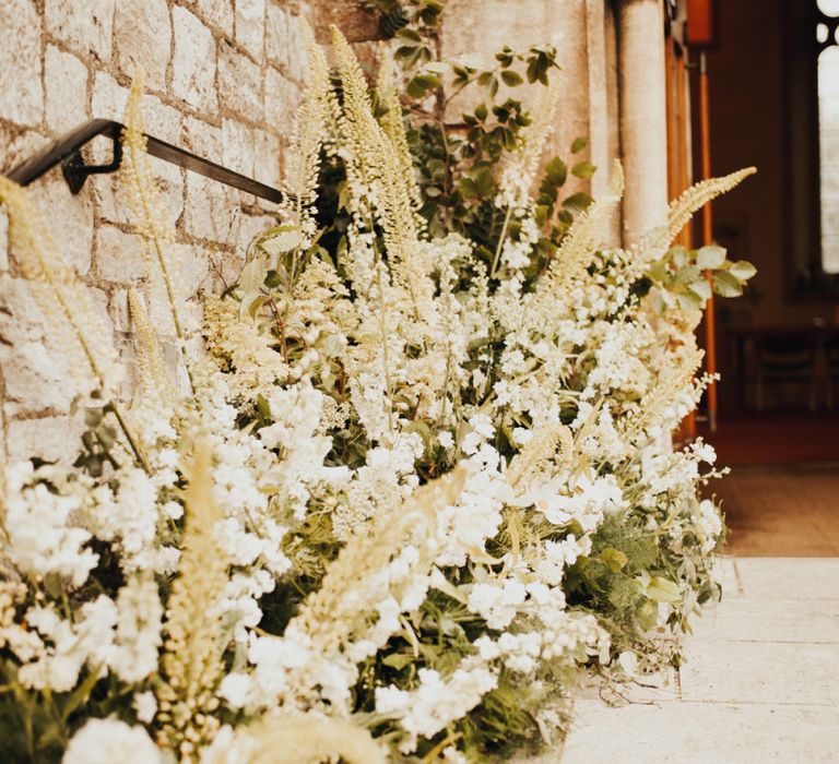 Wedding flowers decorate the church for ceremony