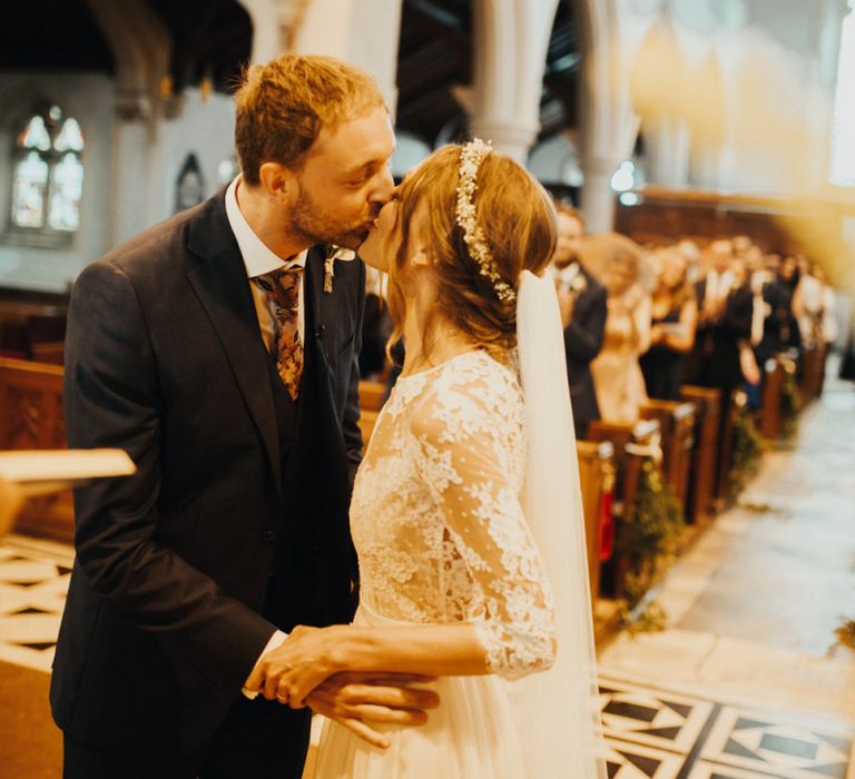 Bride and groom seal vows with a kiss