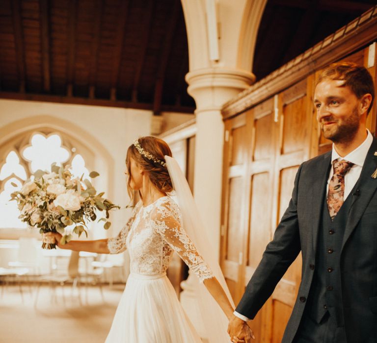 Bride in lace dress with veil and flower crown