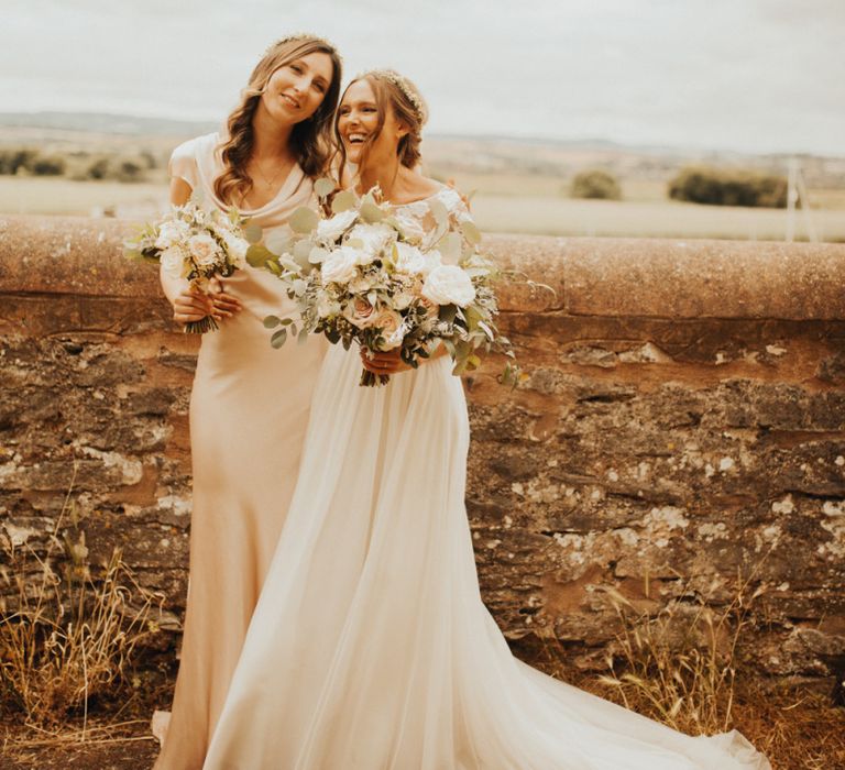 Bride with bridesmaid in pink dress