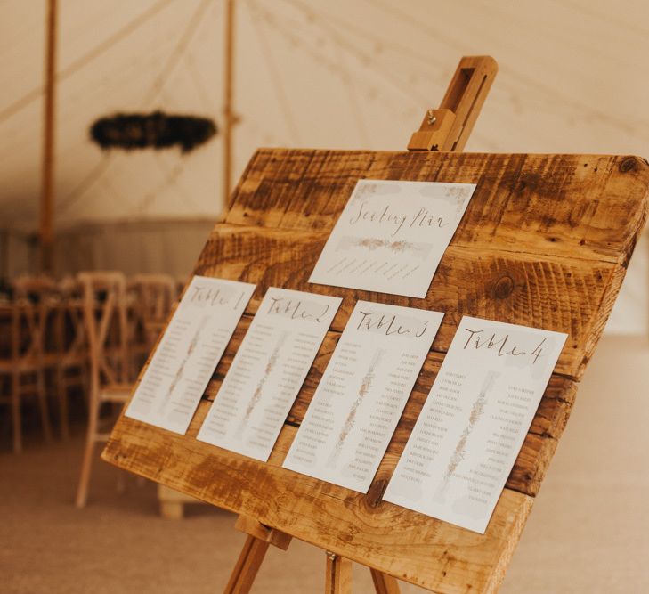 Wooden wedding signs with foliage table runner and floral chandelier