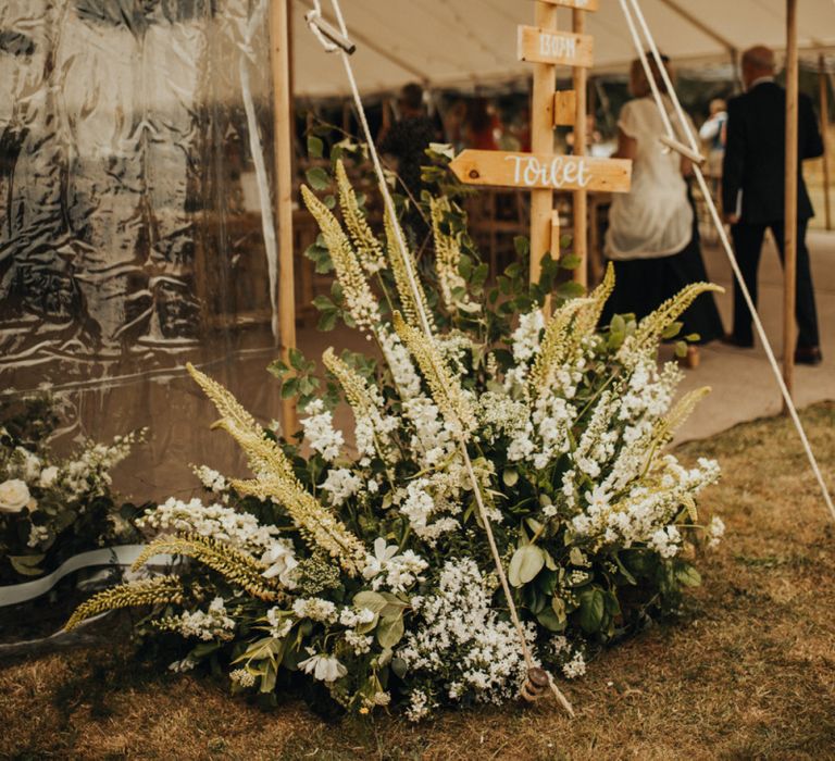 Wooden wedding sign at marquee wedding