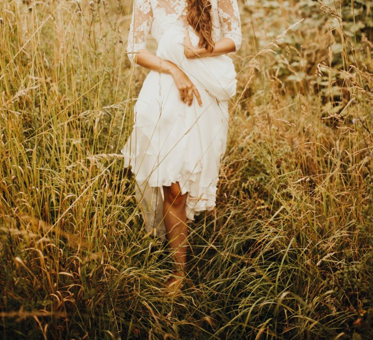 Bride wears long sleeved wedding dress with flower crown