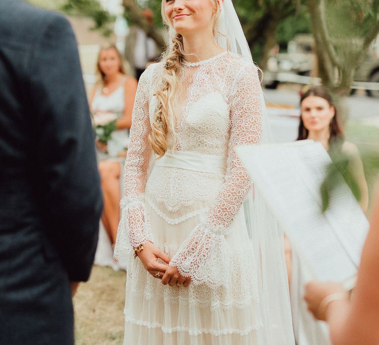 Wedding Ceremony | Bride in Laced Catherine Deane Wedding Dress with Long Sleeves | Rustic French Destination Wedding with Homegrown Flowers  | Emily &amp; Steve Photography