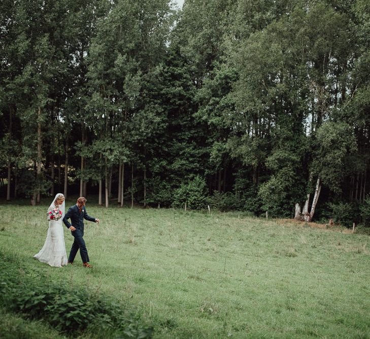 Bride in Laced Catherine Deane Wedding Dress with Long Sleeves | Groom in Blue Thomas Farthing Suit with Ochre Tie | Rustic French Destination Wedding with Homegrown Flowers  | Emily &amp; Steve Photography