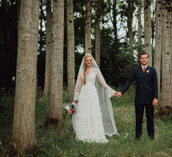 Bride in Laced Catherine Deane Wedding Dress with Long Sleeves | Groom in Blue Thomas Farthing Suit with Ochre Tie | Rustic French Destination Wedding with Homegrown Flowers  | Emily &amp; Steve Photography