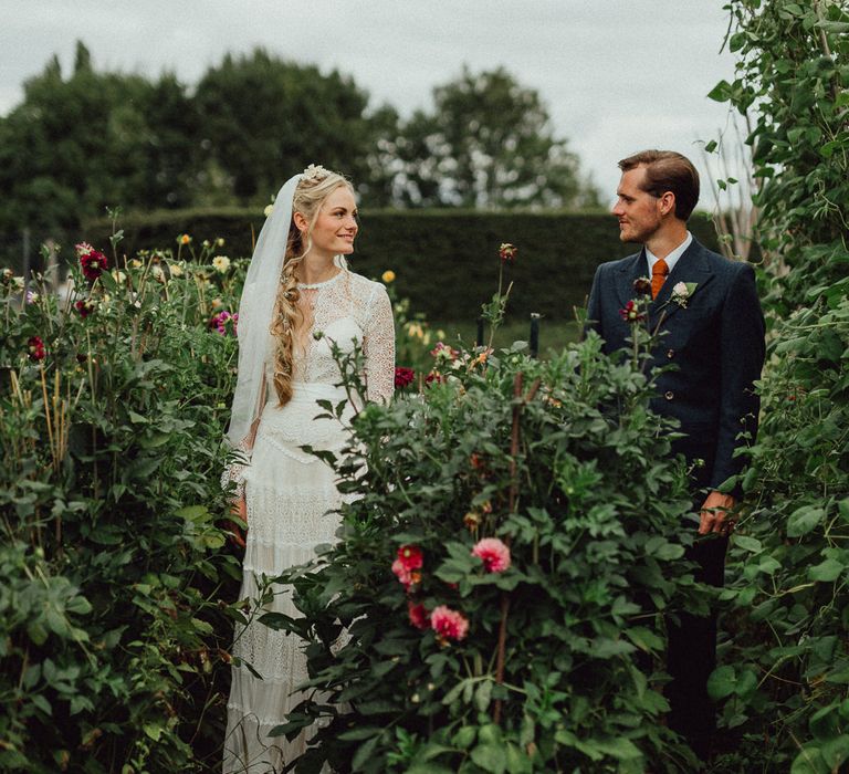 Bride in Laced Catherine Deane Wedding Dress with Long Sleeves | Groom in Blue Thomas Farthing Suit with Ochre Tie | Rustic French Destination Wedding with Homegrown Flowers  | Emily &amp; Steve Photography