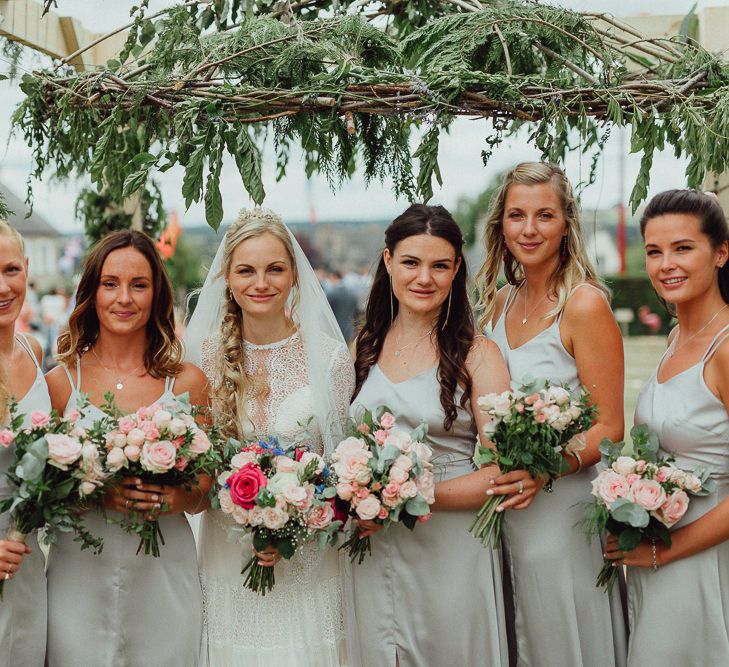 Bride in Laced Catherine Deane Wedding Dress with Long Sleeves | Bridesmaids in Grey Silk Fred Dresses | Foliage Arch | Rustic French Destination Wedding with Homegrown Flowers  | Emily &amp; Steve Photography