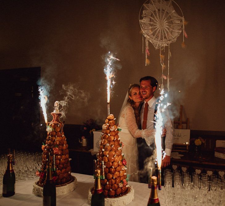 Croquembouche Cakes | Bride in Laced Catherine Deane Wedding Dress with Long Sleeves | Groom in Blue Thomas Farthing Suit with Ochre Tie | Rustic French Destination Wedding with Homegrown Flowers  | Emily &amp; Steve Photography