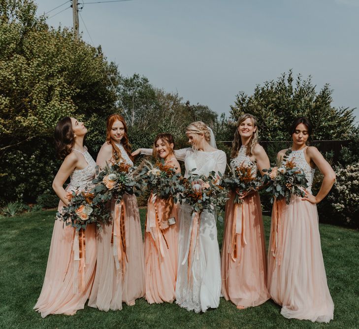 Bridal Party Portrait with Bridesmaids in Peach and White Separates and Bride in Lace Wedding Dress with Long Sleeves