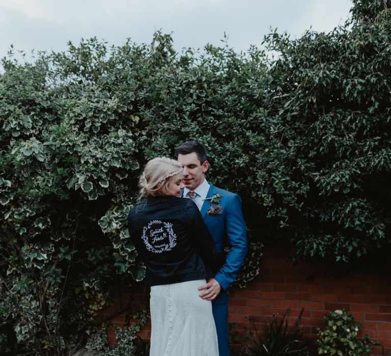 Bride in Lace Allure Bridals Wedding Dress and Customised Leather Jacket