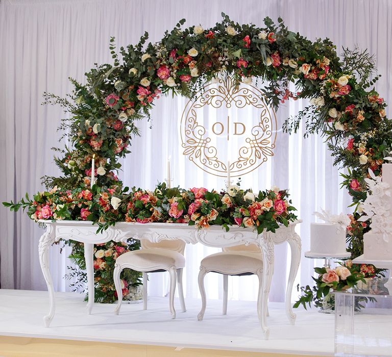 Sweetheart Table With Floral Arch Backdrop