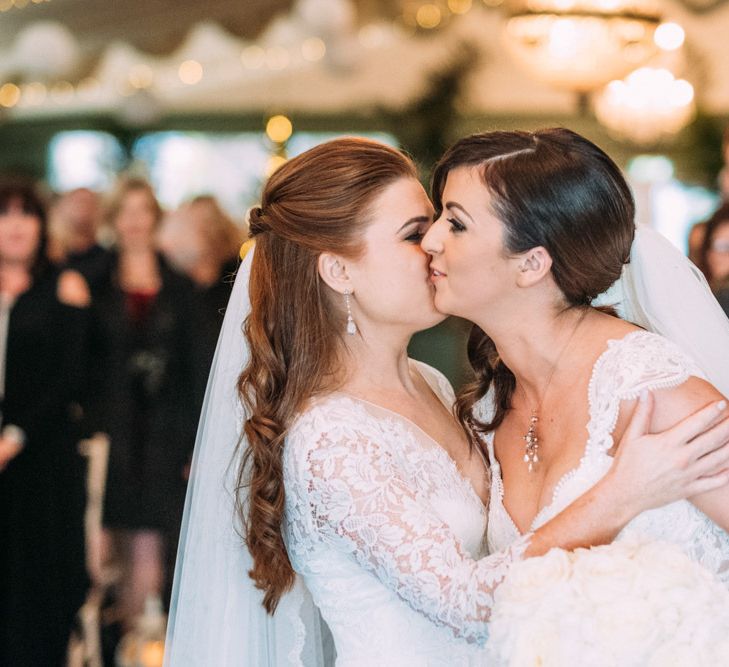 Wedding Ceremony at Tinakilly House with Two Brides Kissing in Lace Wedding Dresses