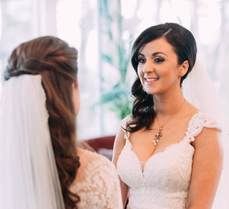 Two Brides in Lace Wedding Dresses Exchanging Vows at Wedding Ceremony